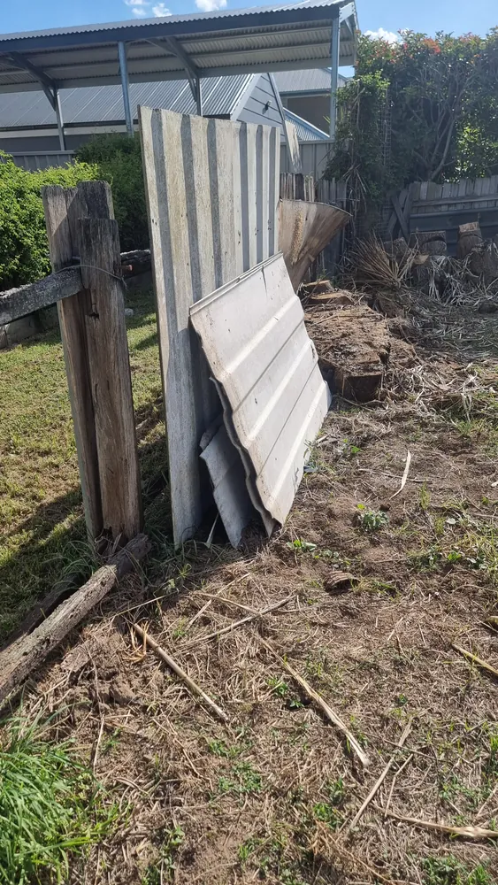 Old fibre-cement sheeting stacked in a yard